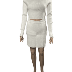 Woman wearing a white knit sweater and matching skirt.