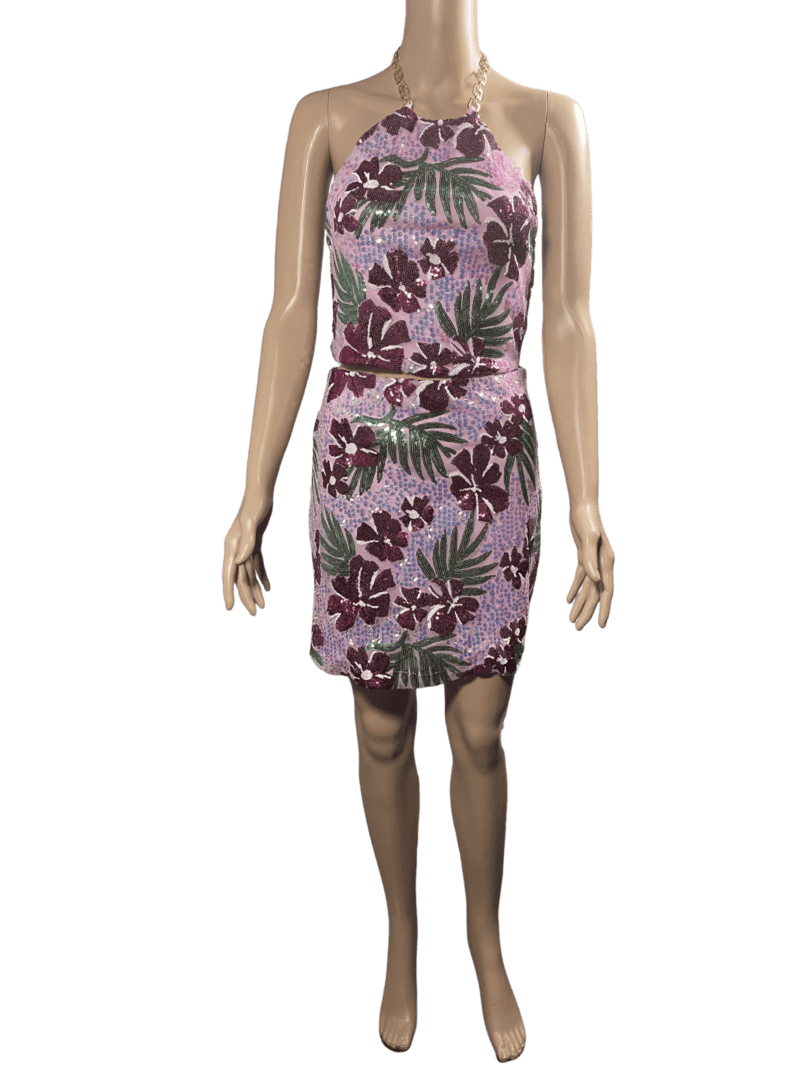 Woman wearing a pink floral sleeveless dress.