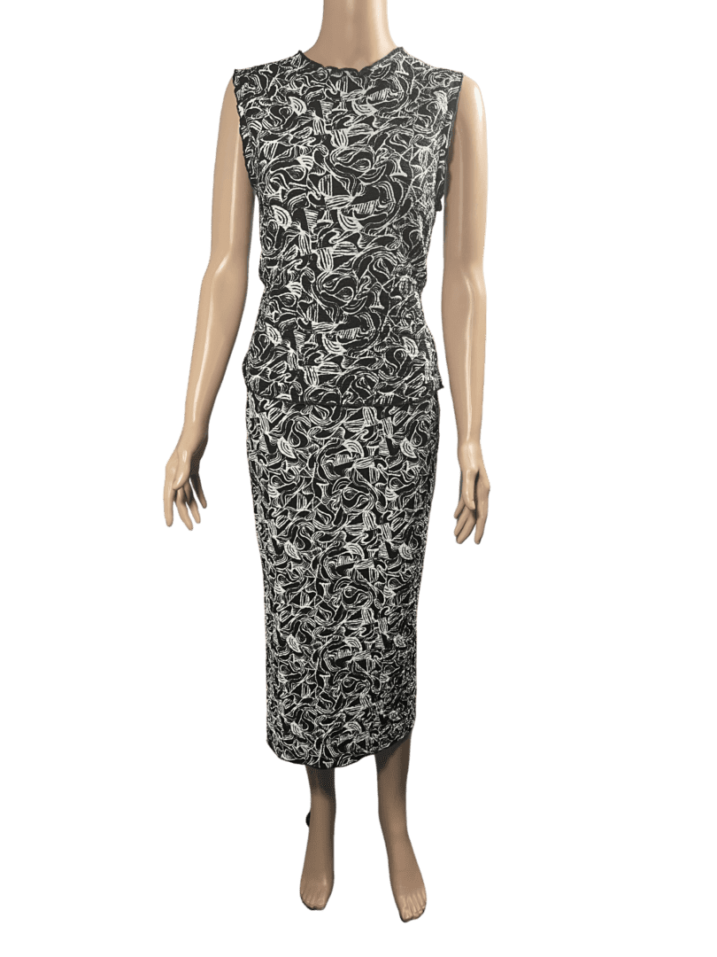 Sleeveless gray and black patterned midi dress on a mannequin.