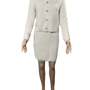 Woman in beige tweed suit with skirt and jacket.