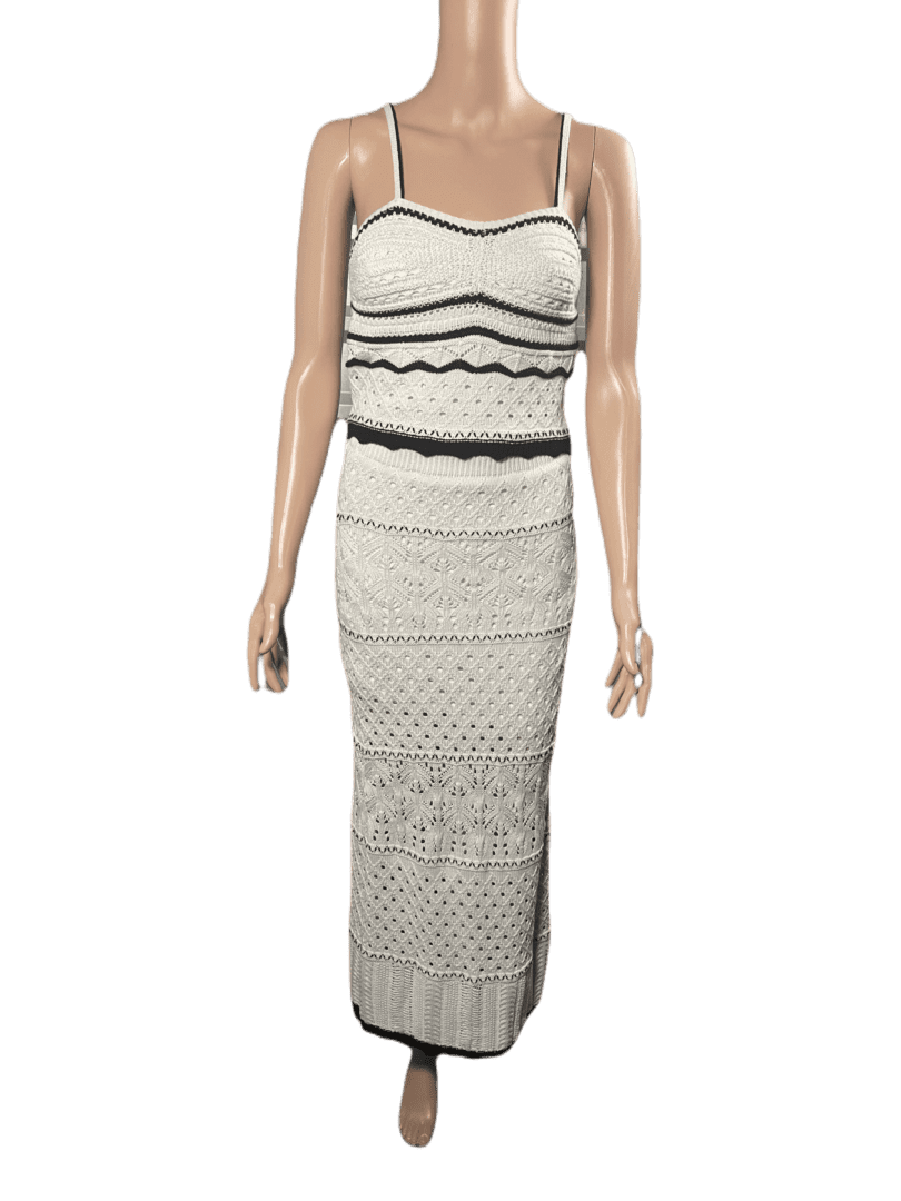 Sleeveless white maxi dress with black trim and crochet details.