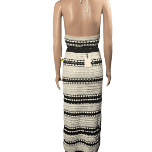 Back view of a person wearing a black and white striped maxi skirt.
