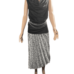 A sleeveless black top paired with a long, pleated silver skirt and a studded belt.