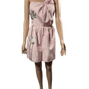Sleeveless pink dress with a large bow on the chest and a cinched waist.