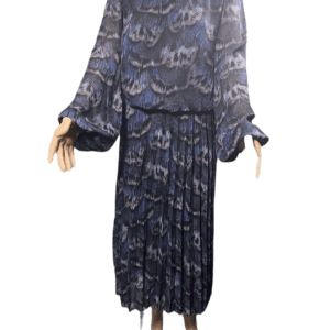 Blue patterned blouse and pleated skirt outfit on a mannequin.