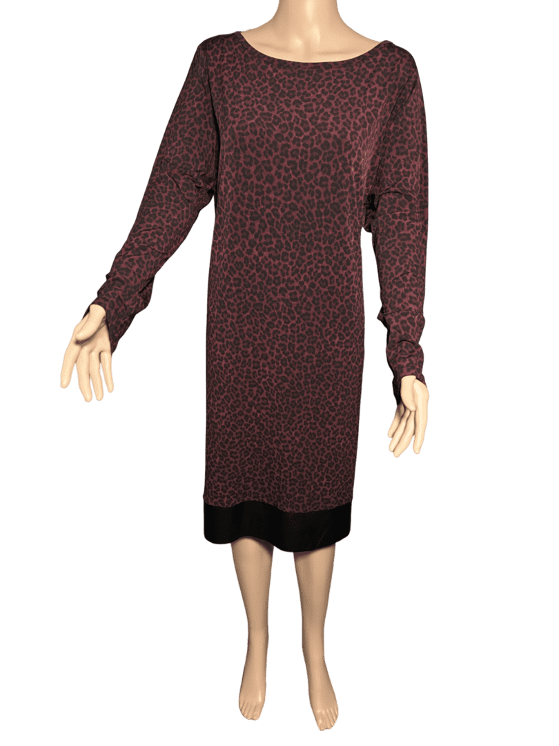 Long-sleeve, knee-length dress with a dark, intricate pattern.