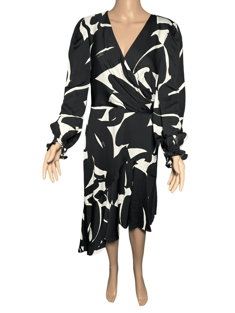 Black and white abstract patterned dress with long sleeves and asymmetrical hem.