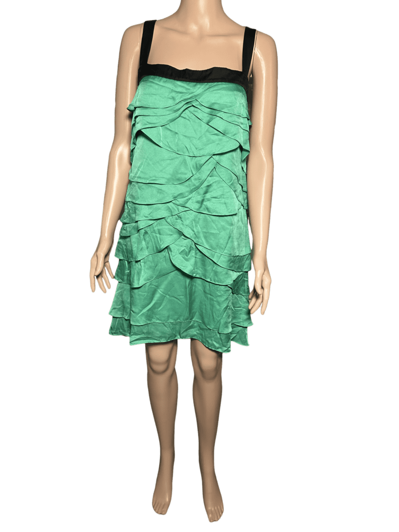 Green strapless dress with layered ruffles on a mannequin.