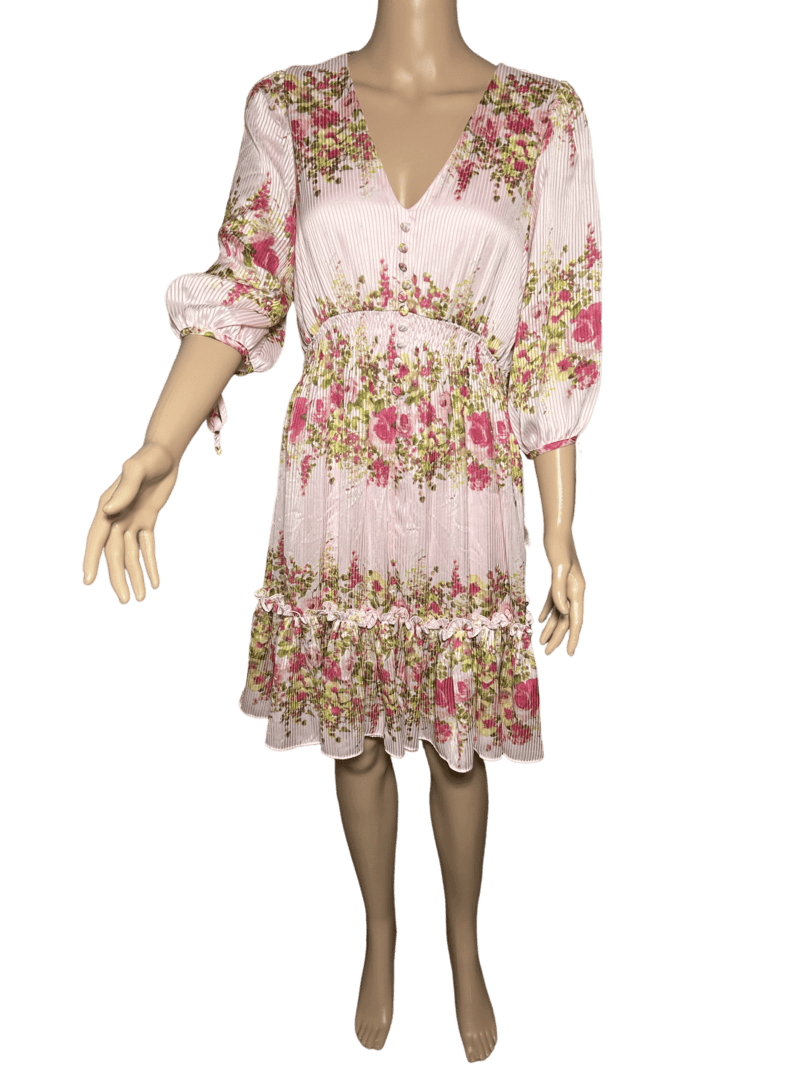 Floral pink dress with ruffled hem and puffed sleeves.