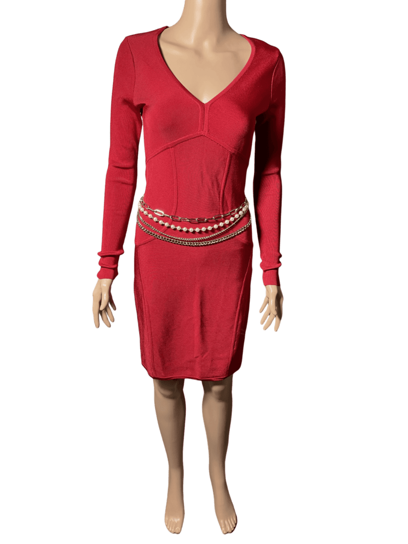 Woman in a red V-neck dress with a decorative belt.