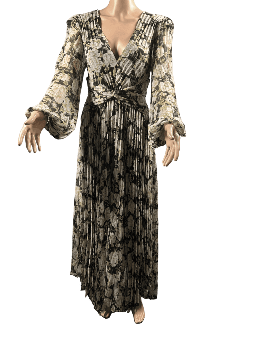 Woman wearing a long floral dress with a deep neckline and long sleeves.