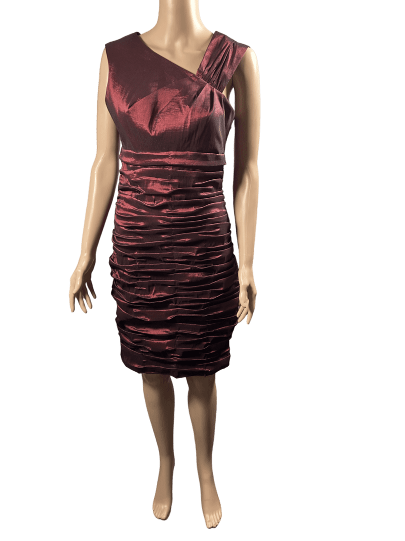 Woman wearing a burgundy ruched satin dress.