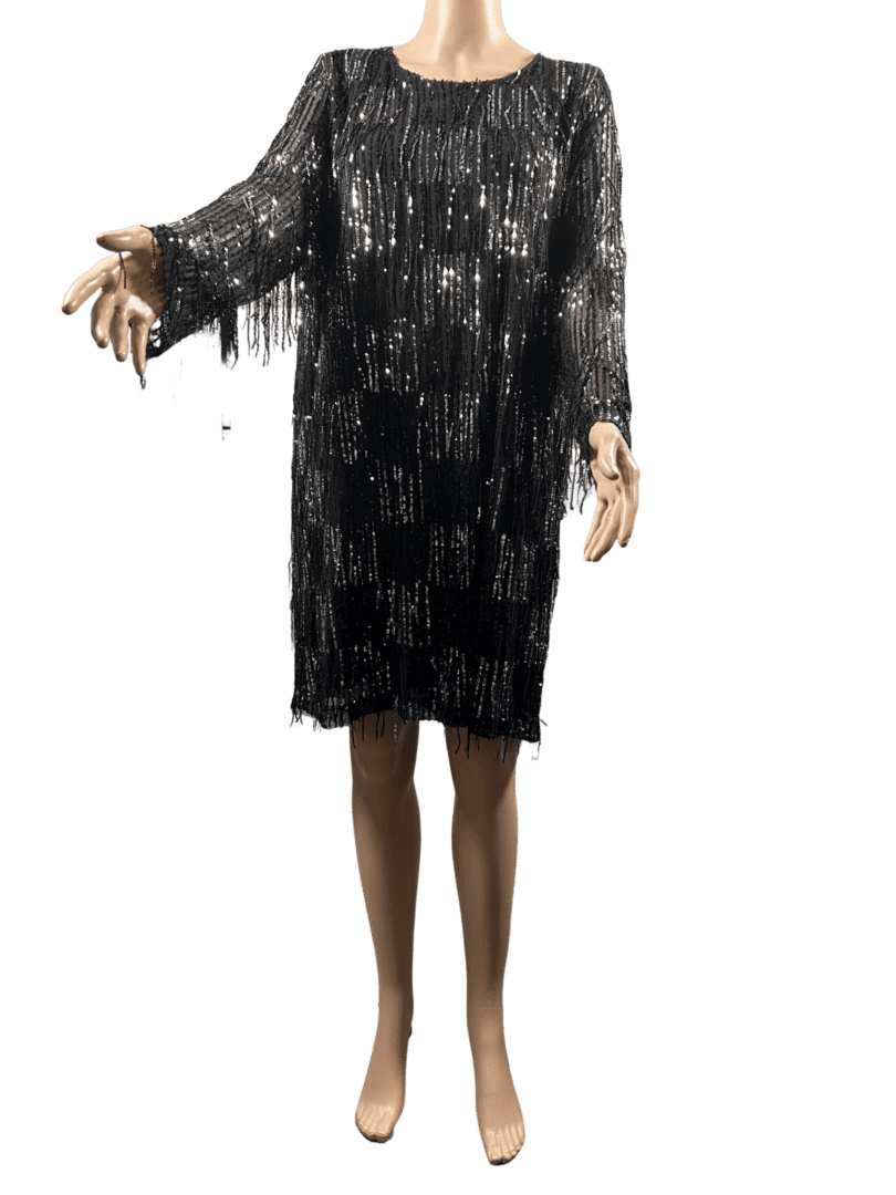 Person wearing a black sequined dress with long sleeves.