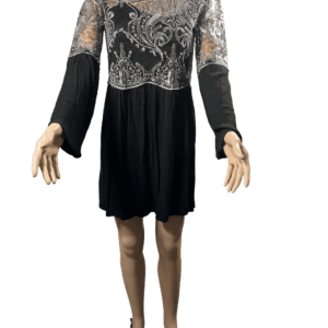 Black dress with lace detailing and long sleeves, worn by a mannequin.