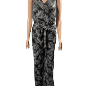 Woman wearing a sleeveless black and gray patterned jumpsuit with a tied waist.