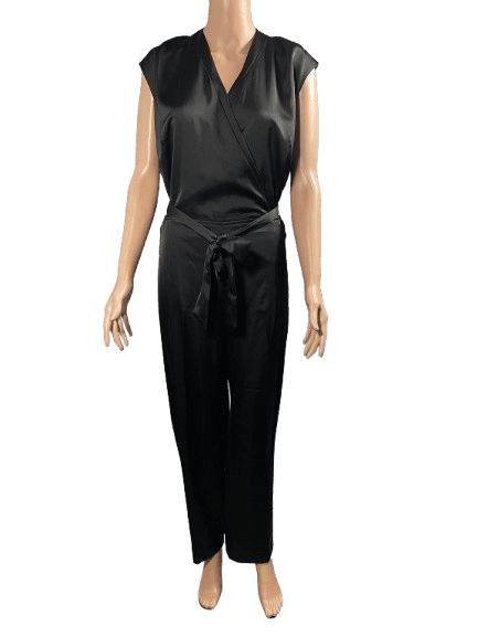 Woman wearing a sleeveless black jumpsuit.