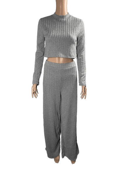 Woman wearing a matching gray ribbed knit crop top and pants set.