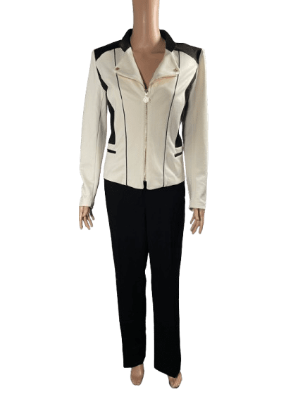 Woman wearing a white jacket and black pants.
