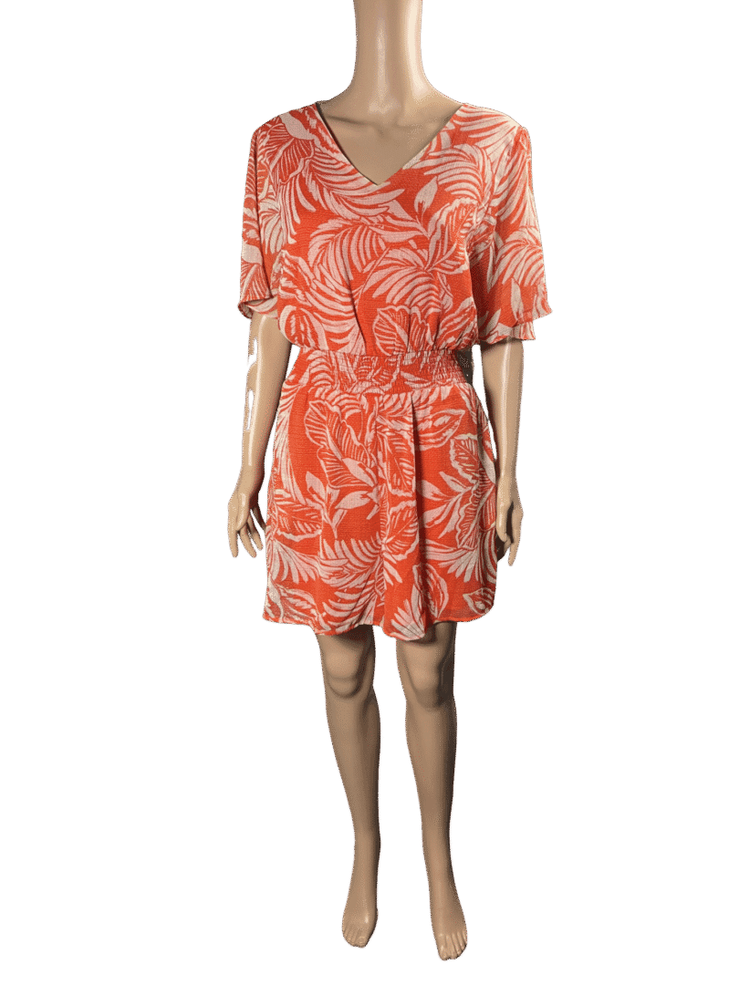 Woman wearing an orange floral dress with a waist tie.