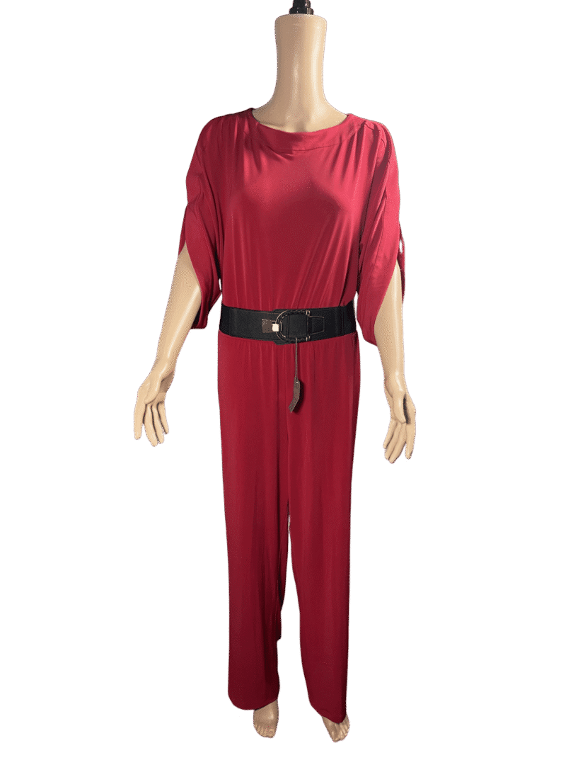 Woman in a stylish red jumpsuit with a black belt.