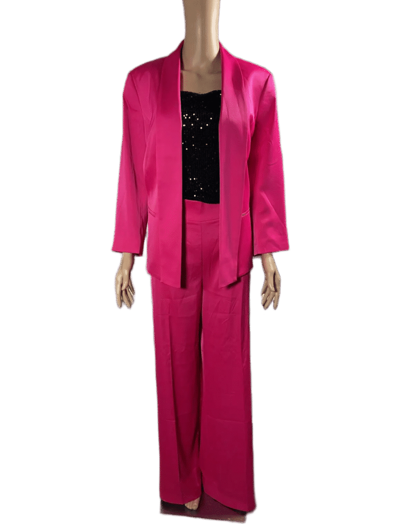Woman wearing a vibrant pink suit with a black top underneath.