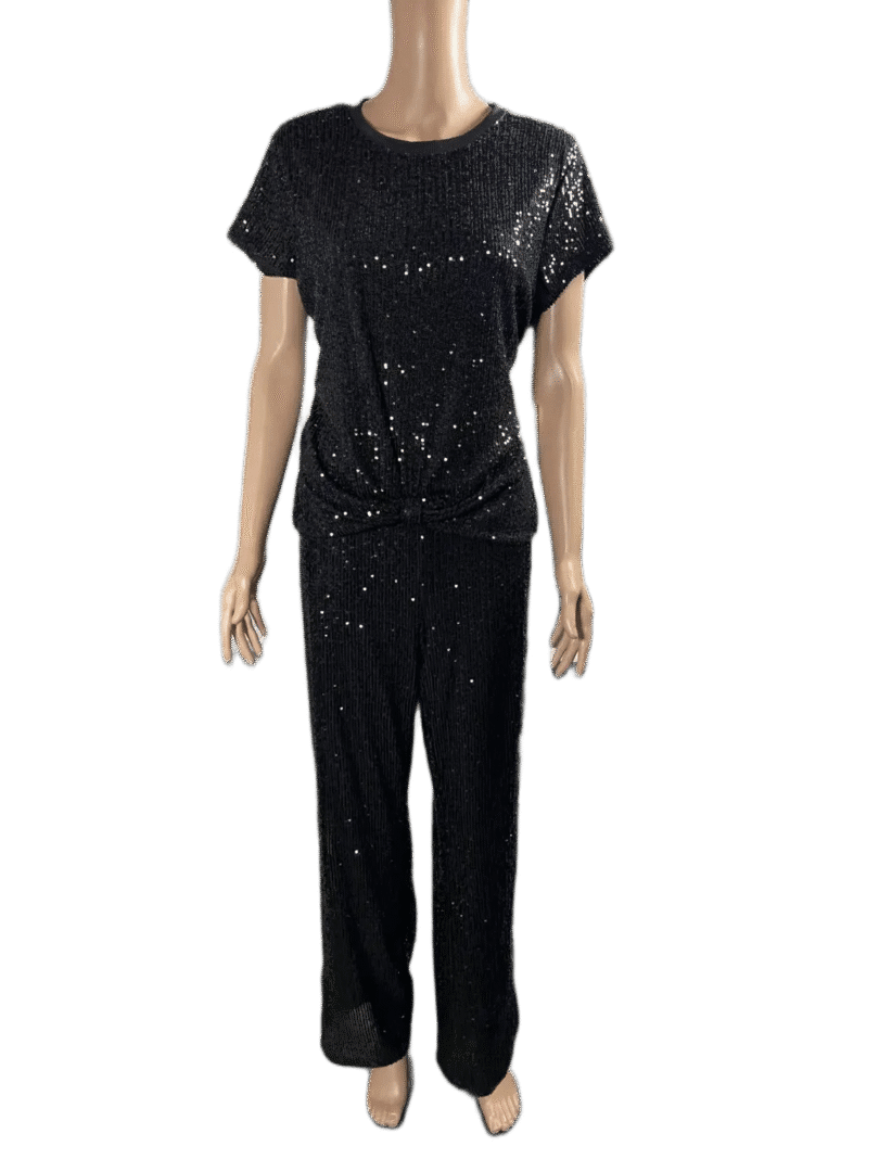 Woman wearing a black sequined top and matching black pants.