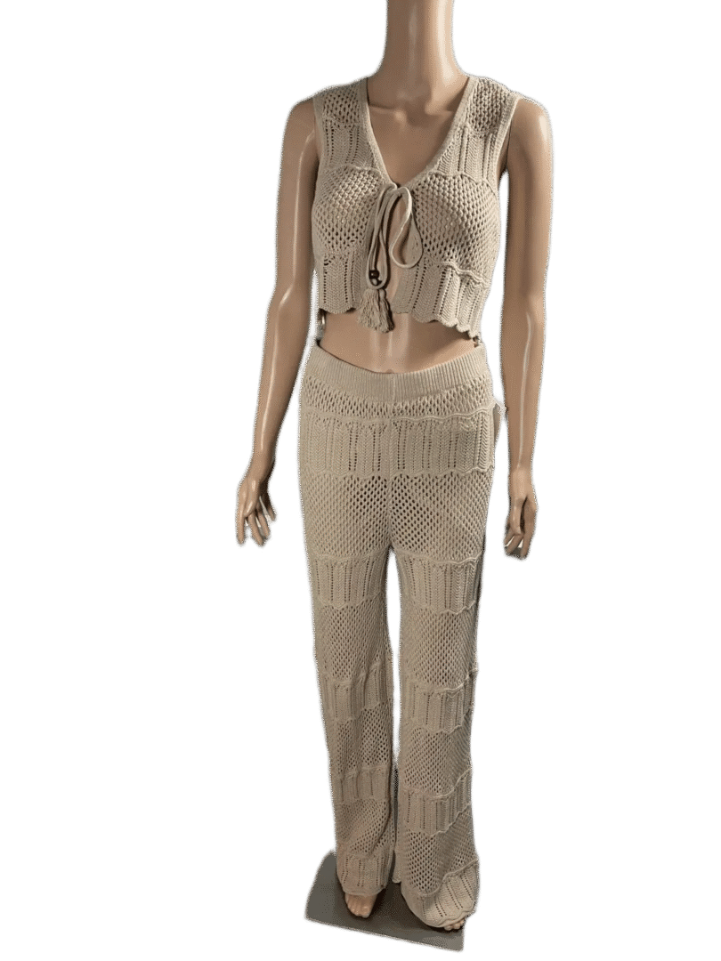 Woman wearing a beige knitted crop top and matching pants.