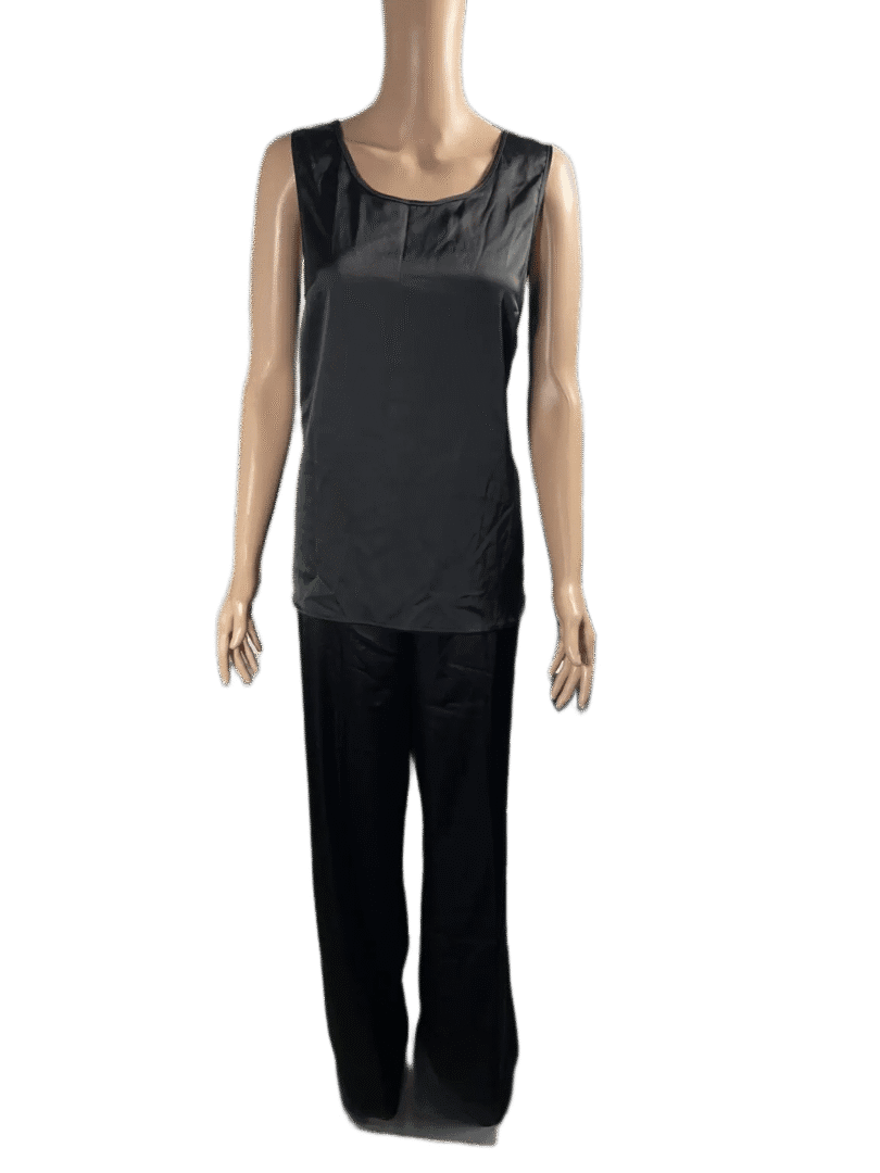 Woman wearing a black sleeveless top and black pants.
