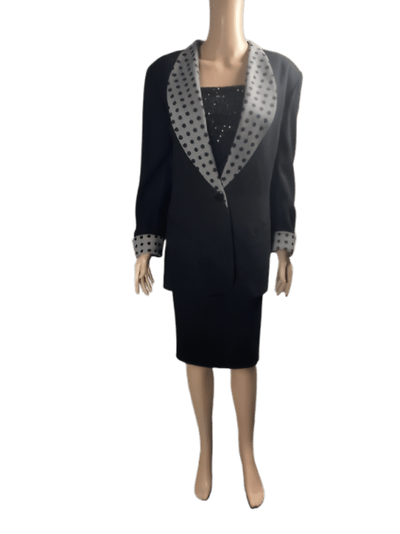 Black dress with shiny silver lapels and cuffs on a mannequin.