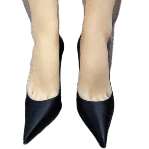 Pair of black pointed-toe high heels worn by a person.