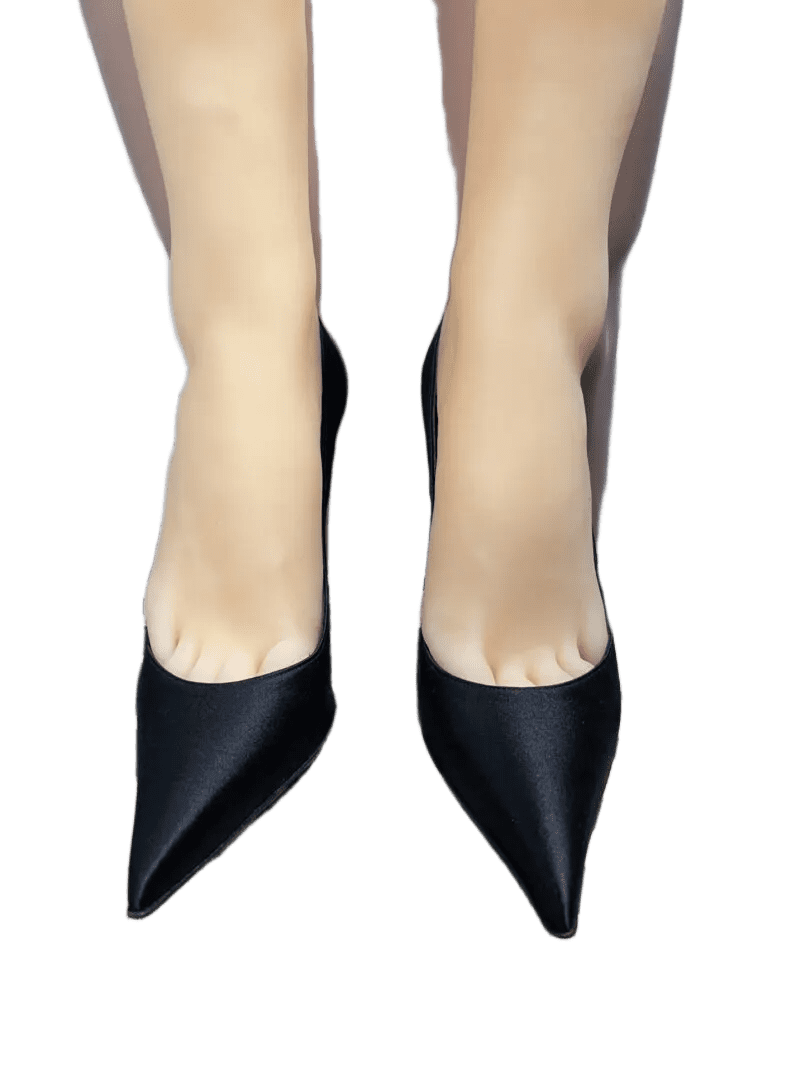 Pair of black pointed-toe high heels worn by a person.