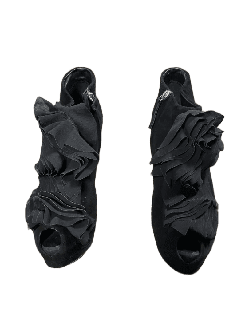 Pair of black open-toe high-heeled sandals with ruffle design.