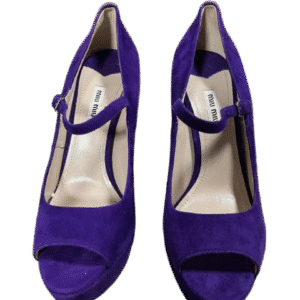 Pair of elegant purple high-heeled shoes with ankle straps.