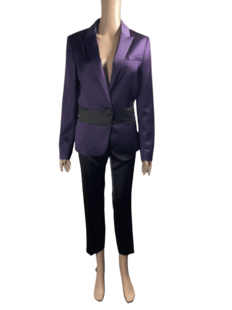 Person wearing a purple blazer and black pants.