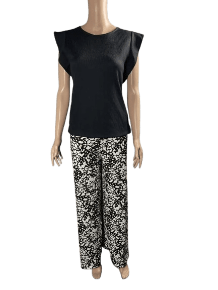 Mannequin wearing a black top and floral patterned pants.