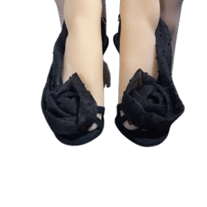 Black shoes with rose-shaped decorations on toes.
