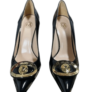 Black pointed-toe high heels with gold Chanel logo embellishments.