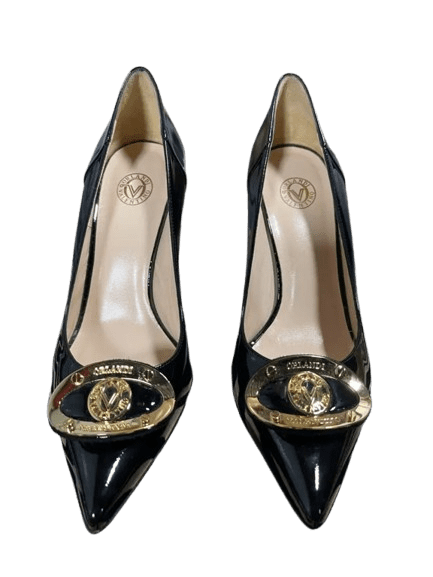 Black pointed-toe high heels with gold Chanel logo embellishments.