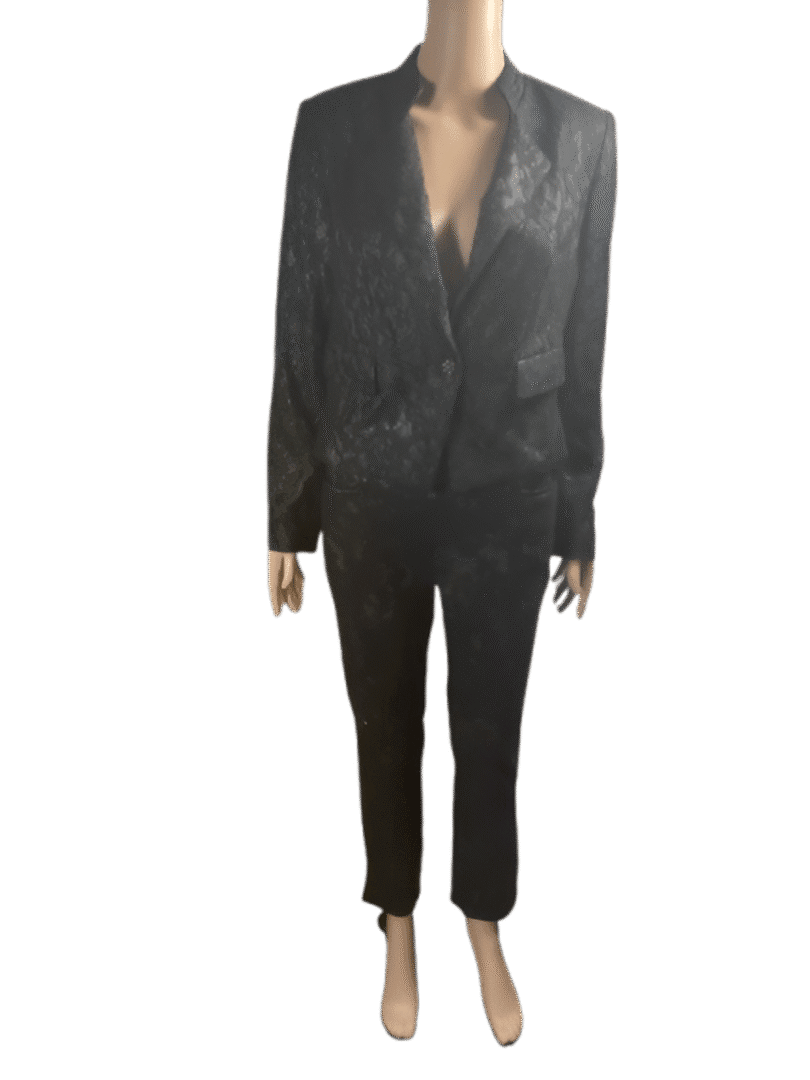 Person wearing a black suit with a blazer and pants.