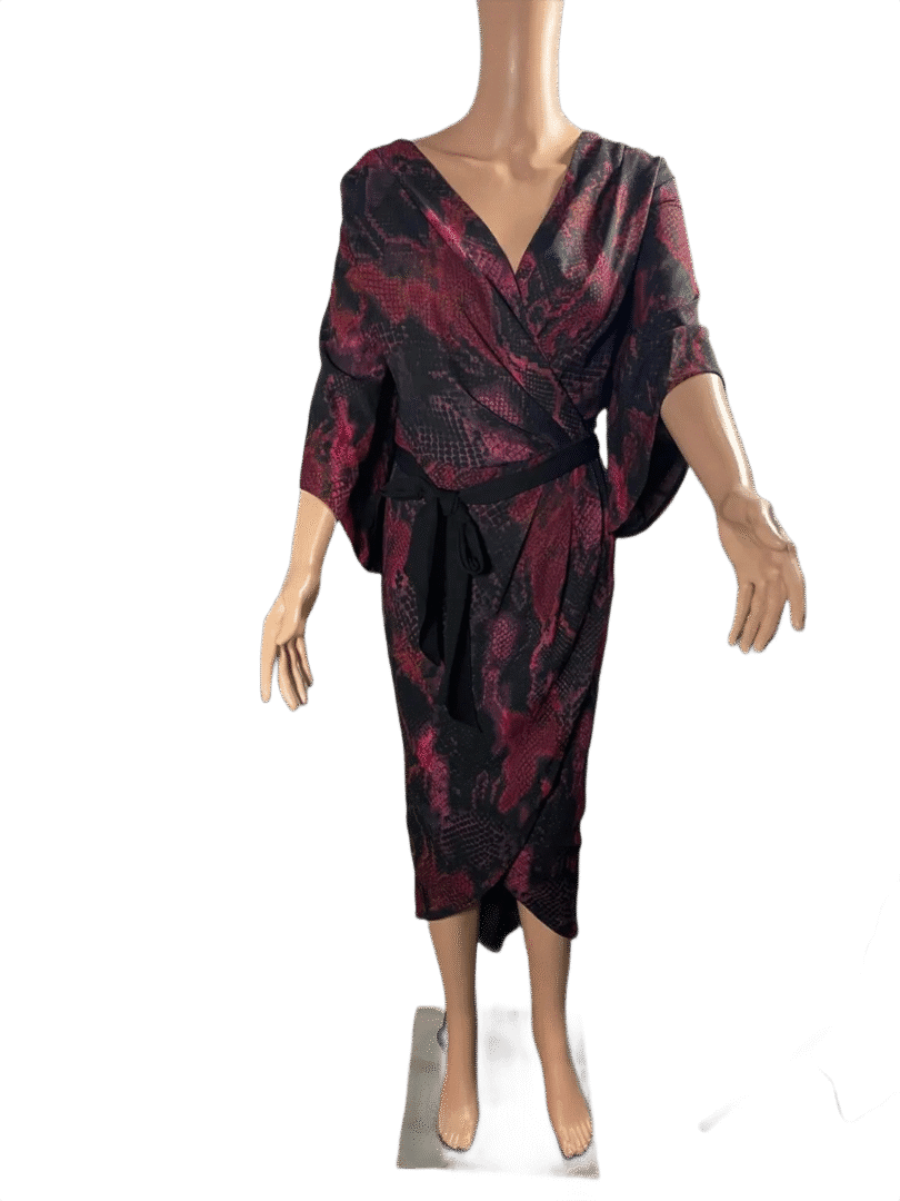 Elegant woman in a dark floral-patterned midi dress with three-quarter sleeves.