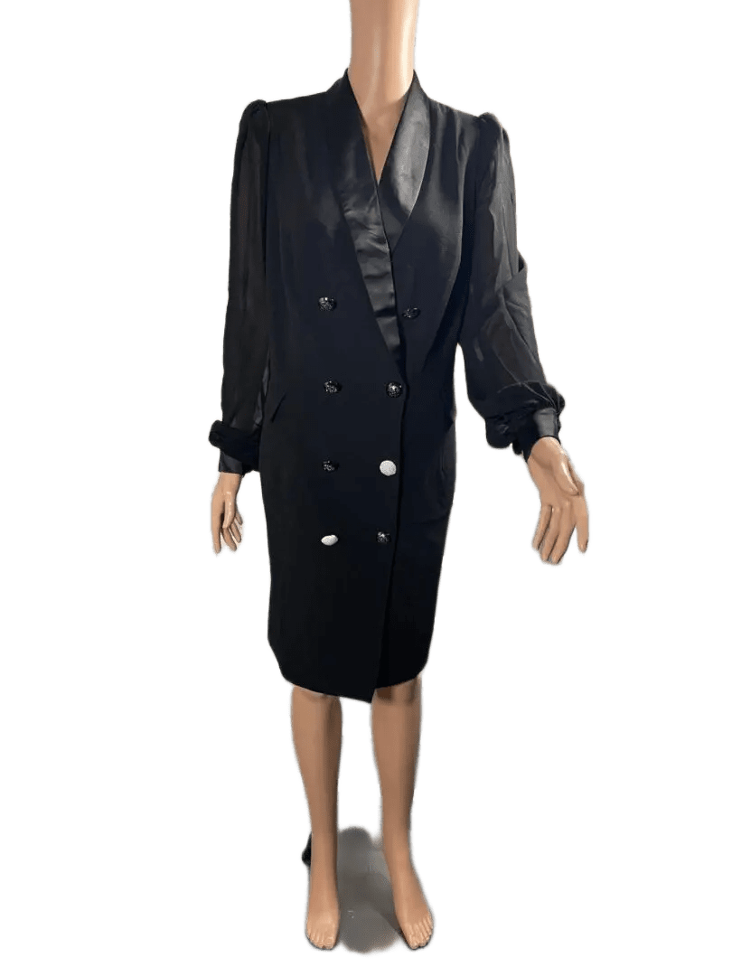 Woman in a black double-breasted dress with sheer sleeves.