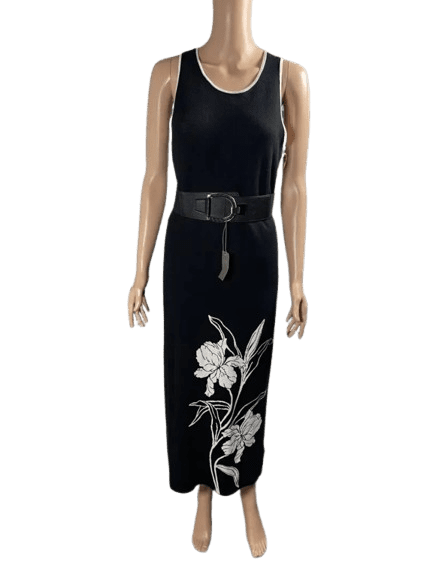 Black sleeveless dress with white floral print and belt.