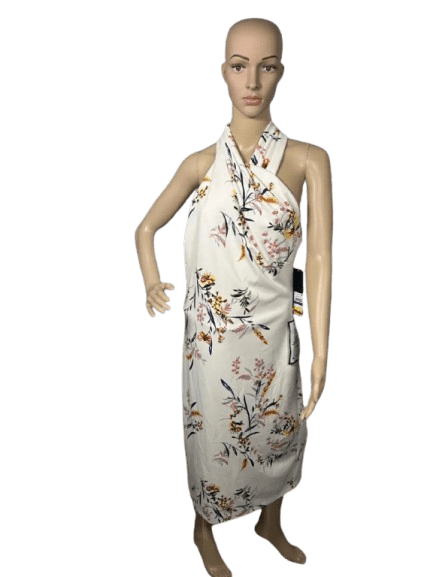 Floral patterned sleeveless dress with halter neck on mannequin.