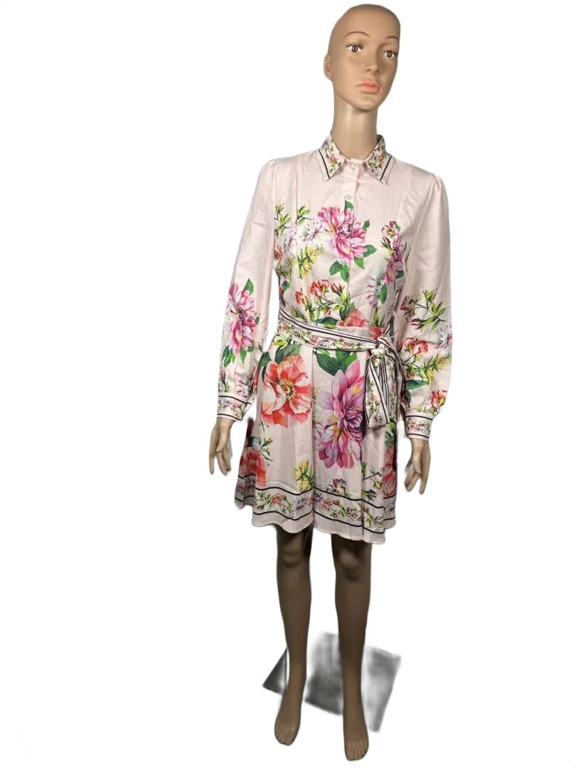 A floral patterned long-sleeve dress in soft pastel colors.