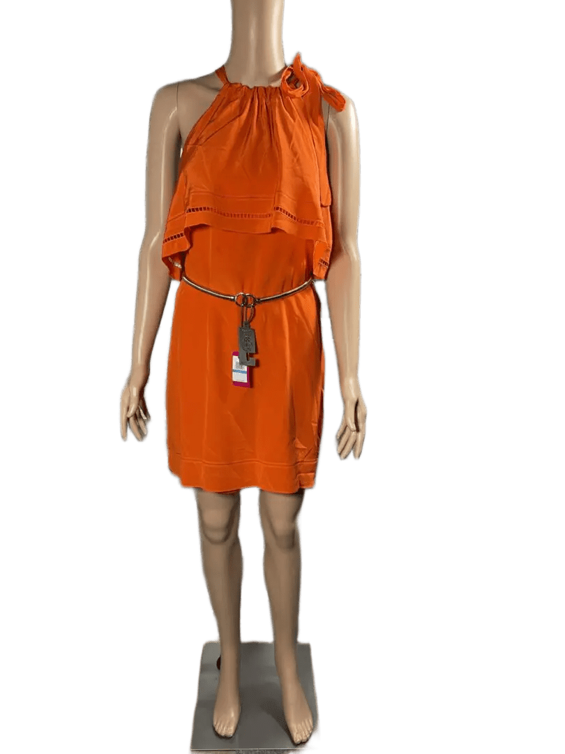Woman wearing an orange dress with black belt and accessories.