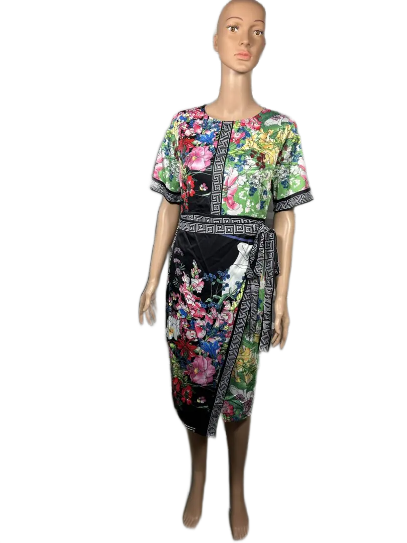 Floral print dress with short sleeves and a side slit on a mannequin.