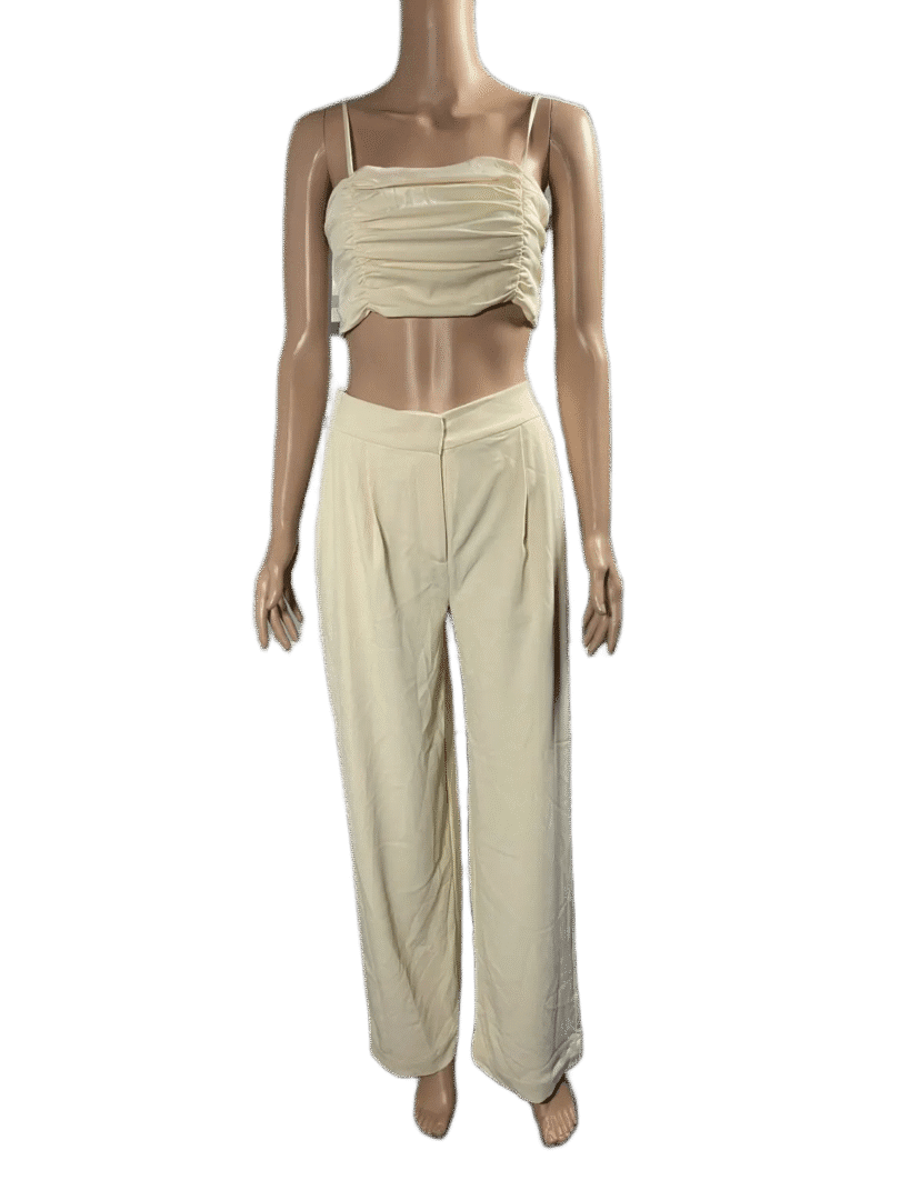 Woman wearing a beige strapless top and matching wide-leg pants.