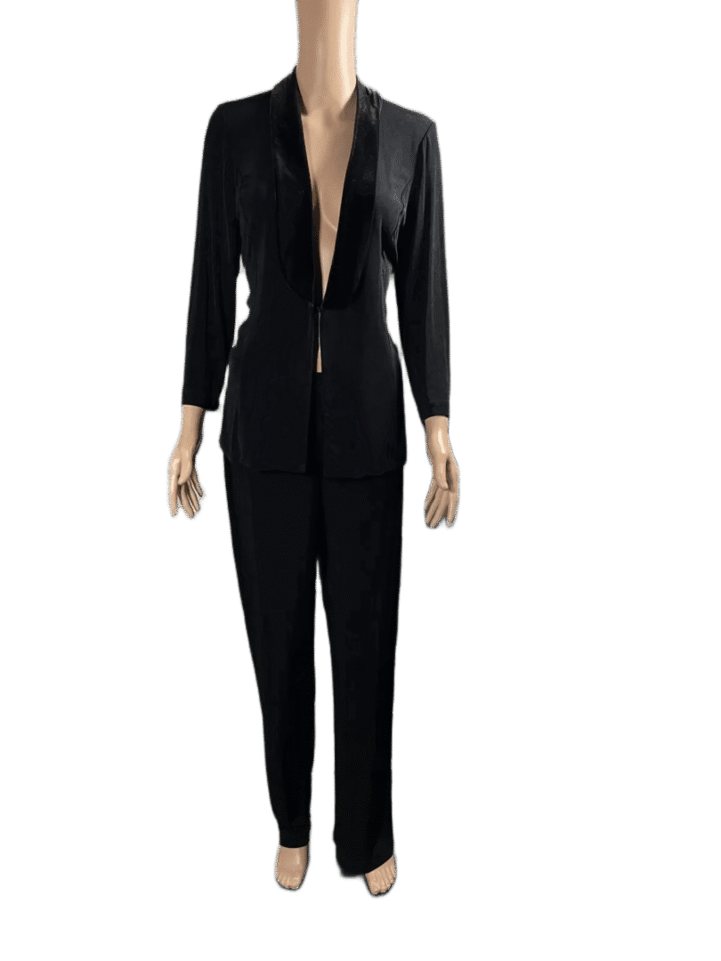 Woman in a stylish black suit with a deep V neckline and tailored pants.