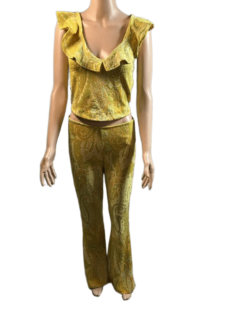 Woman wearing a shiny gold outfit with ruffled top and pants.