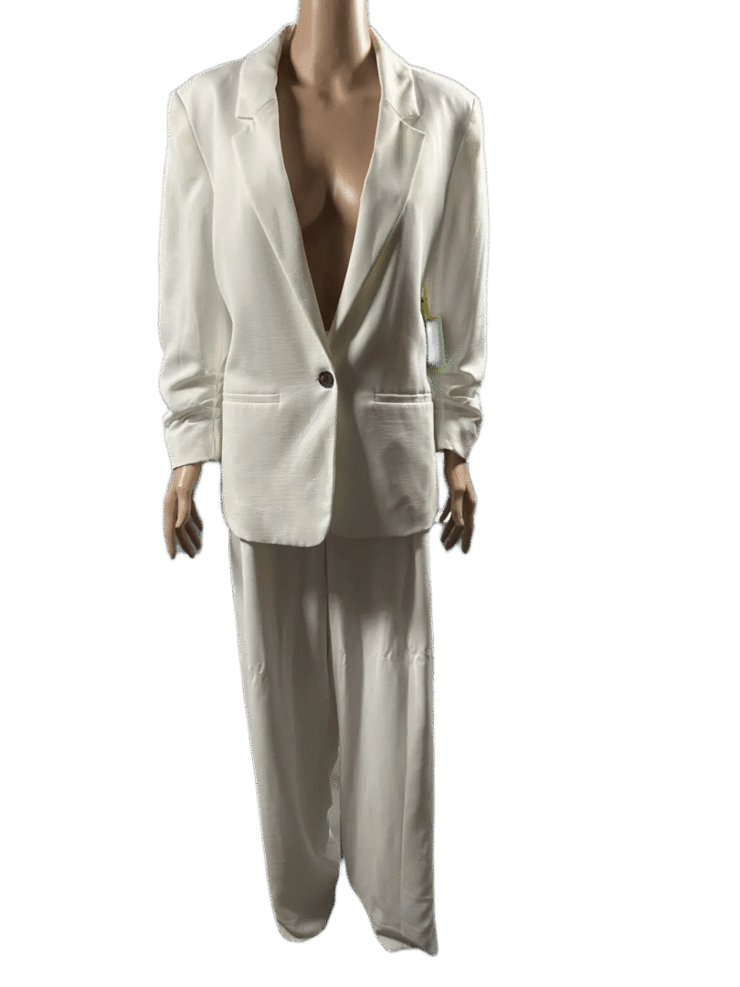 Woman wearing an oversized white suit with wide-legged pants.